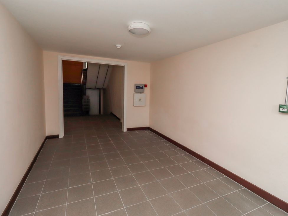 A hallway with a staircase and electrical panel at Amber Rose in Berwick-Upon-Tweed