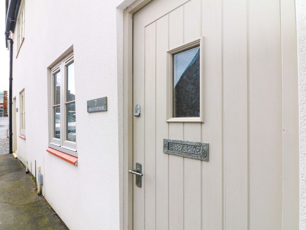 An entrance with a door and window at Jolly Cottage in Derby