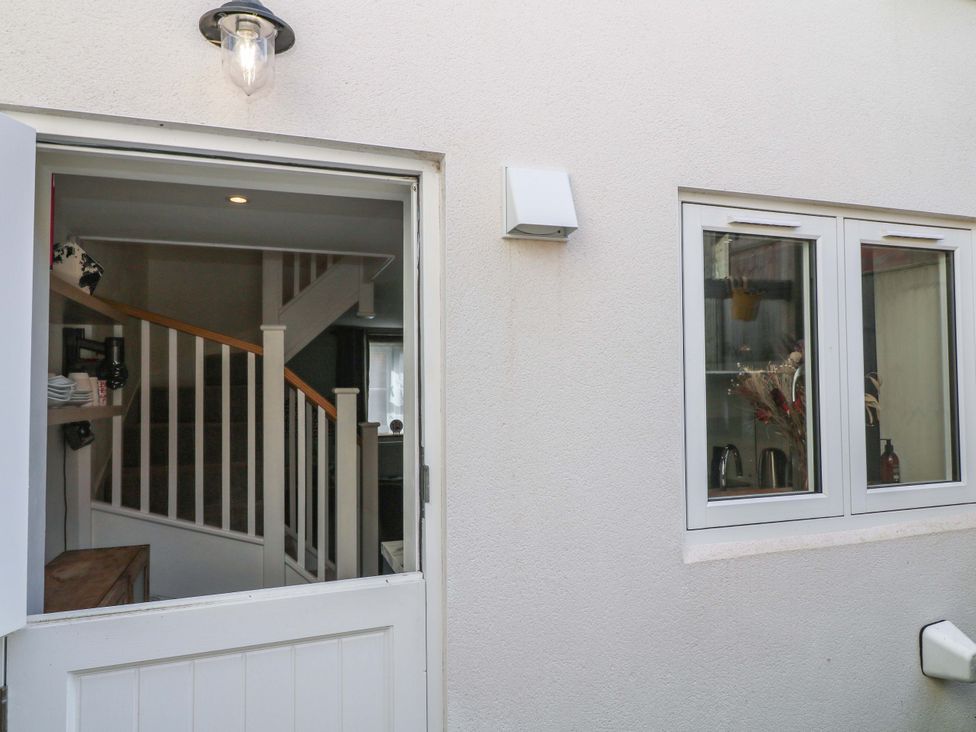 An entryway with a door and stairs at Jolly Cottage in Derby