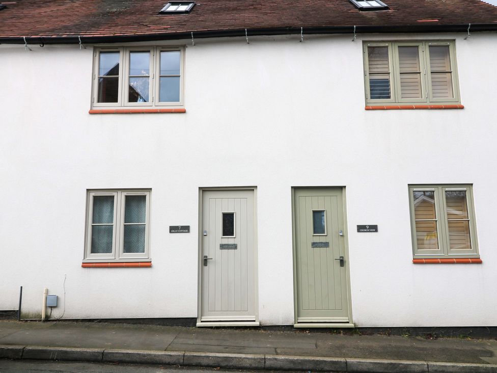 An outdoor view of two doors and windows at Jolly Cottage in Derby