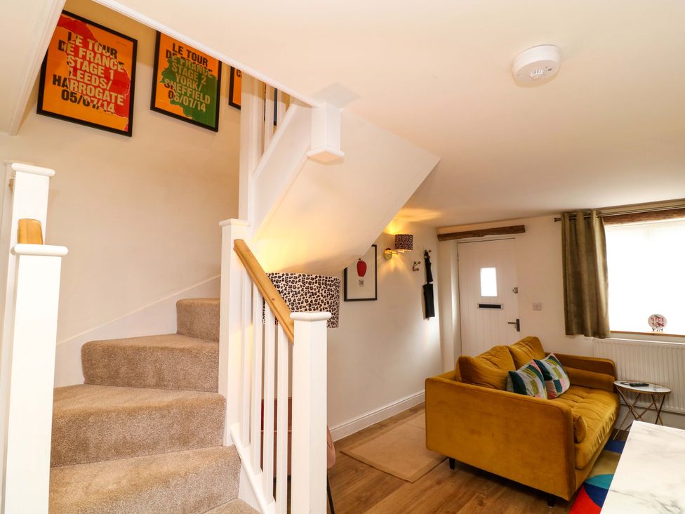 A living room with a staircase and a sofa at Jolly Cottage Derby