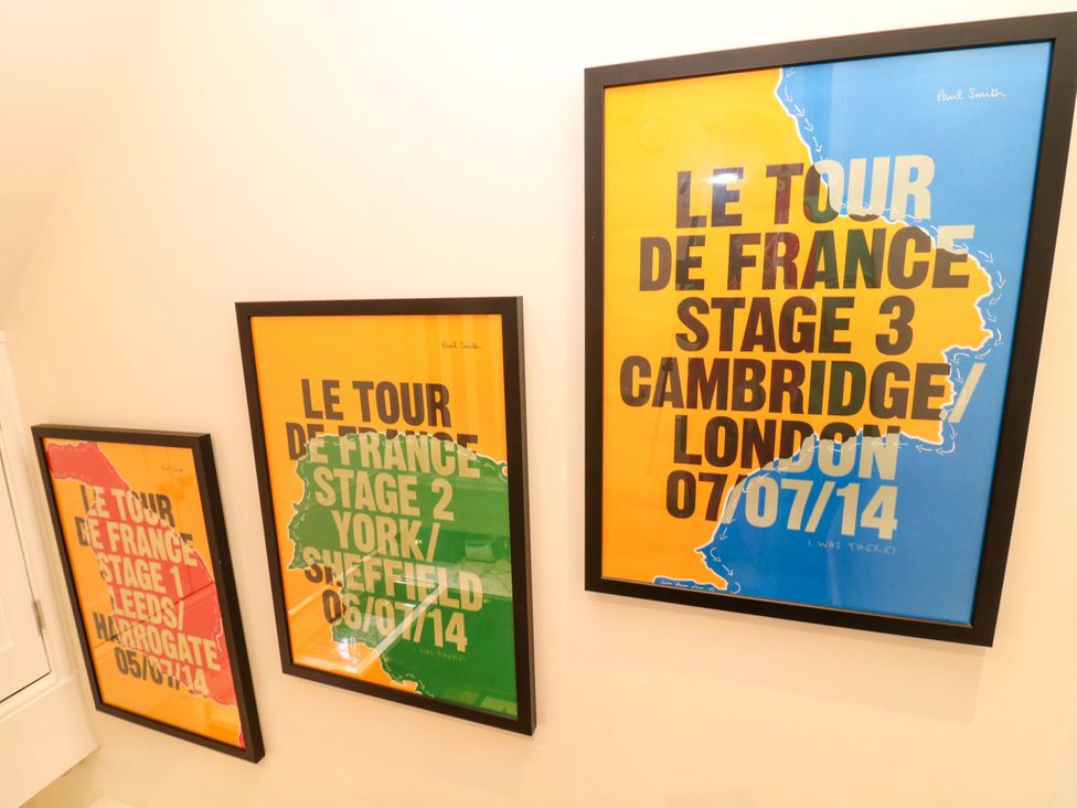 Three framed posters of Le Tour de France stages in a hallway at Jolly Cottage in Derby