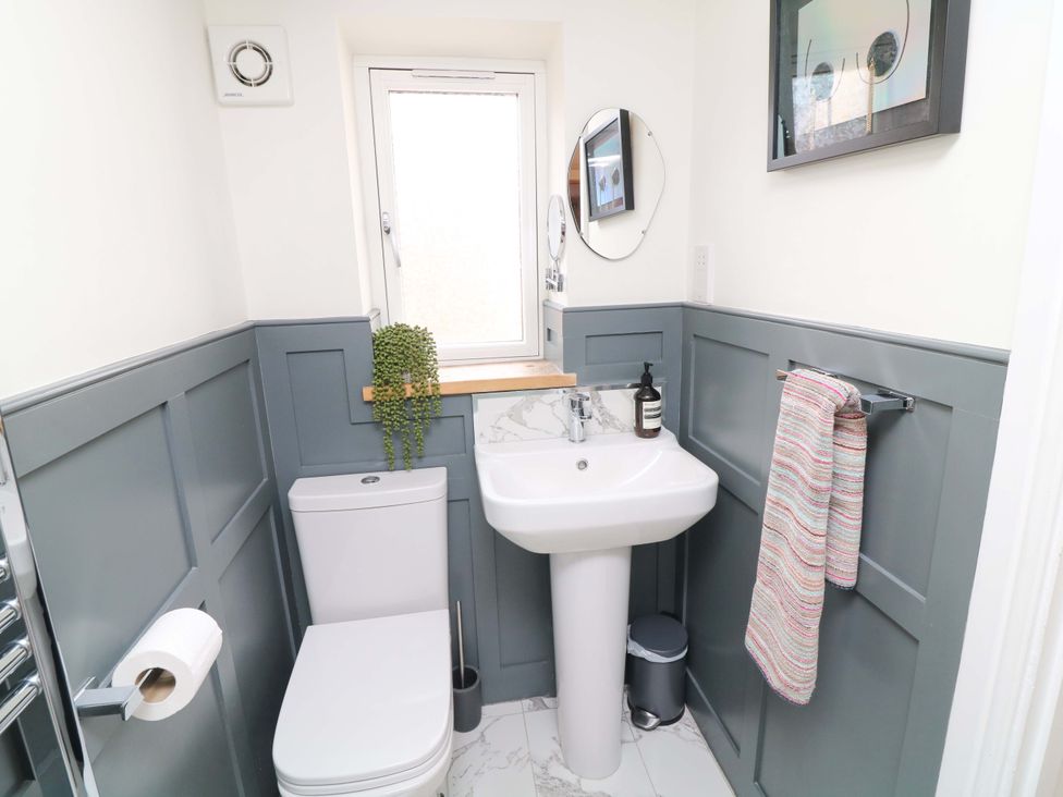 A bathroom with a toilet and sink at Jolly Cottage in Derby