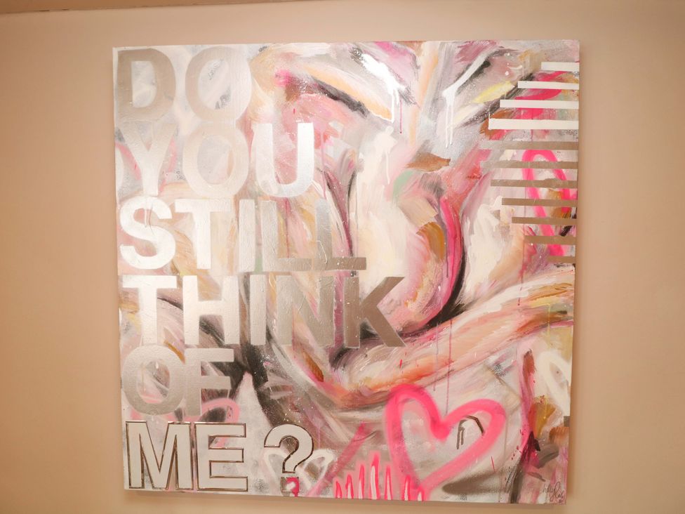 An abstract artwork with text on a canvas at Jolly Cottage in Derby