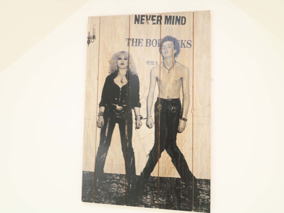 A poster featuring two figures at Jolly Cottage in Derby