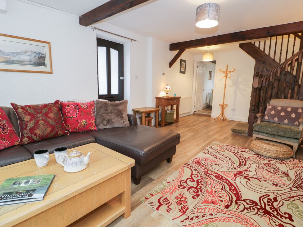 A living room with a sofa and coffee table at Ivy Cottage in Abergele