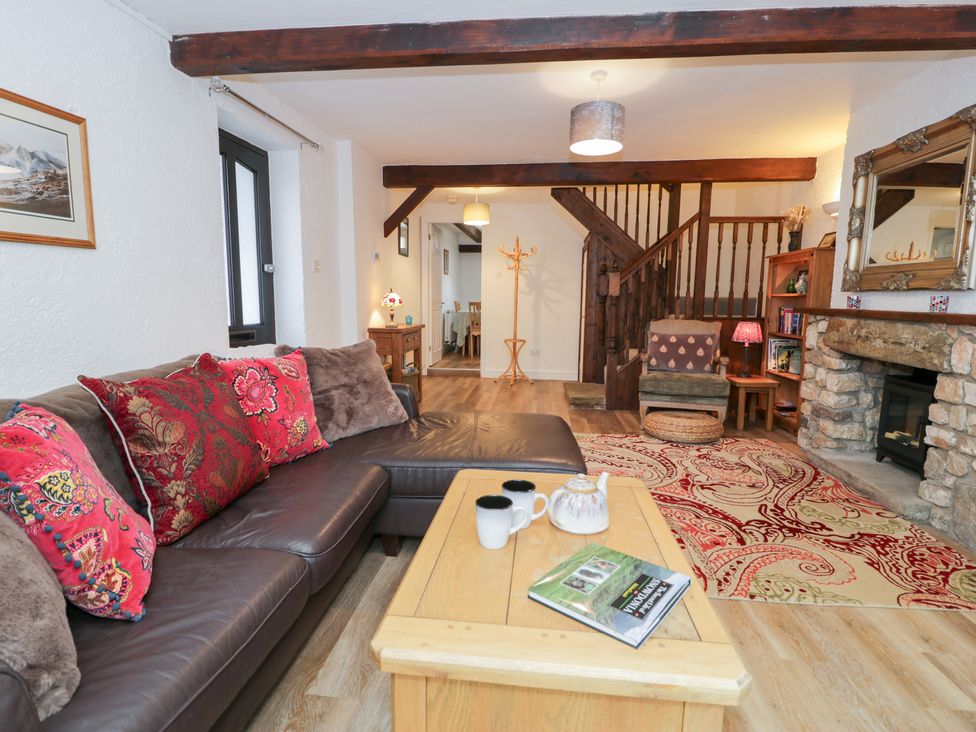 A living room with a sofa and coffee table at Ivy Cottage in Abergele