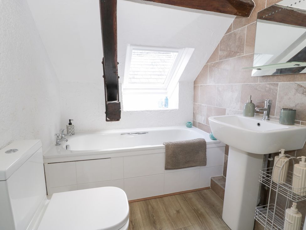 A bathroom with bathtub and sink at Ivy Cottage in Abergele