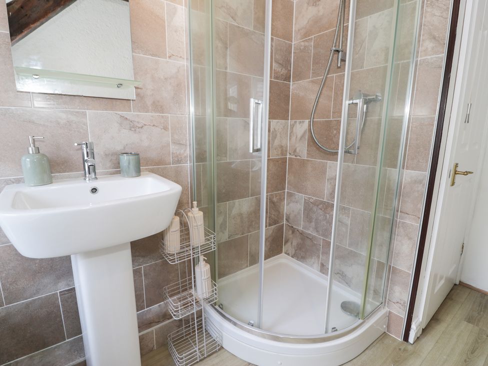 A bathroom with a shower and sink at Ivy Cottage in Abergele
