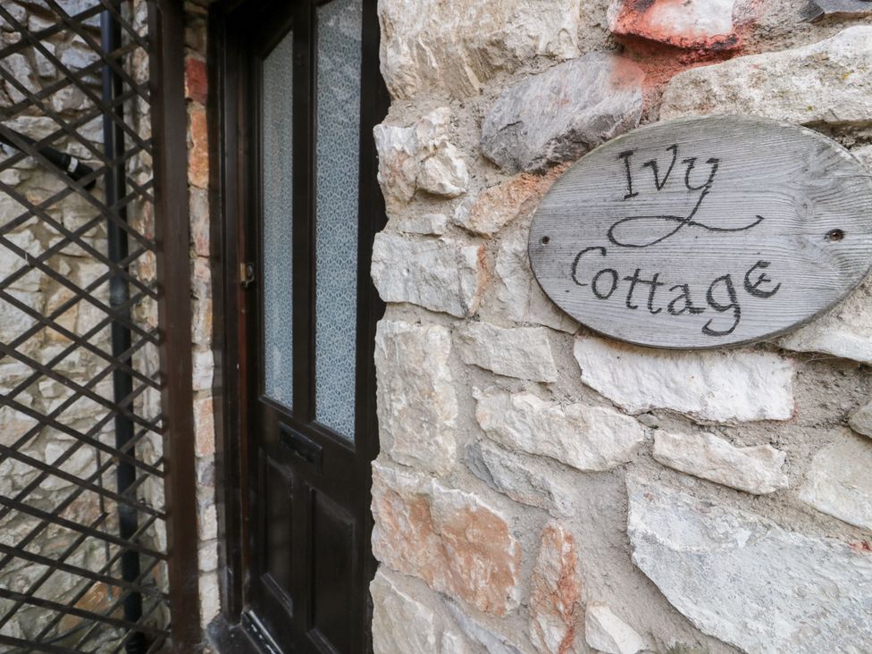 An entrance with a door and nameplate at Ivy Cottage in Abergele