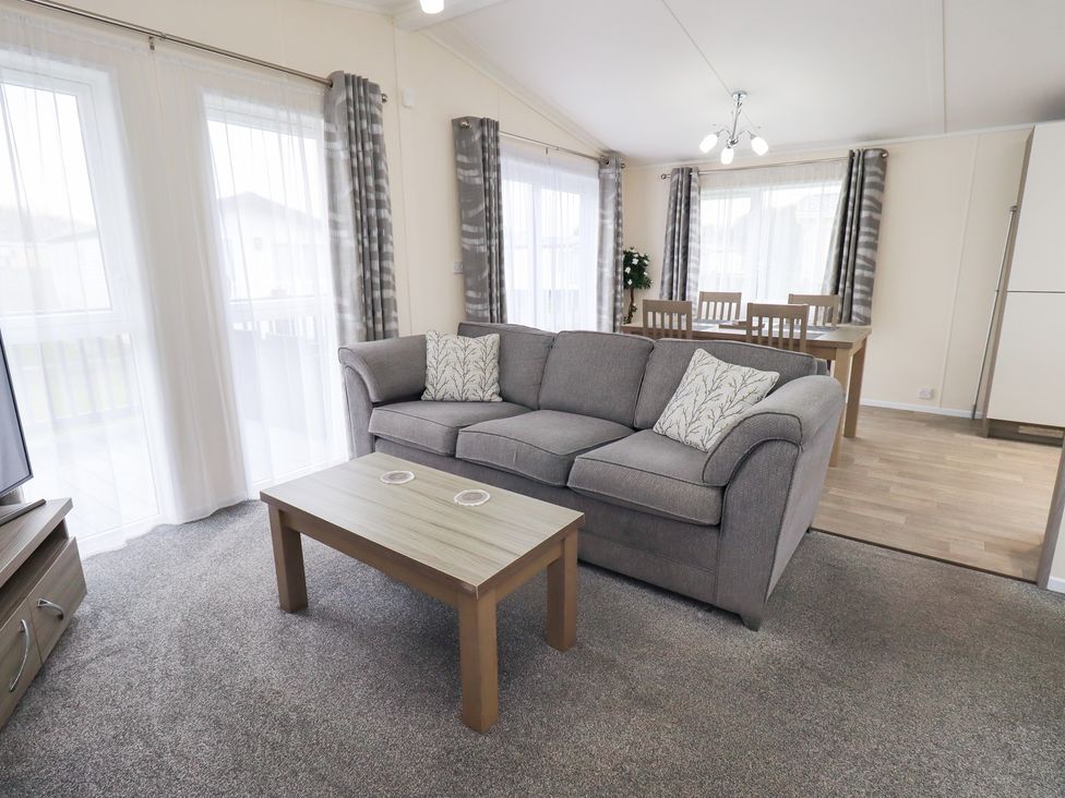 A living room featuring a sofa and coffee table at Lily's Lodge in Morecambe
