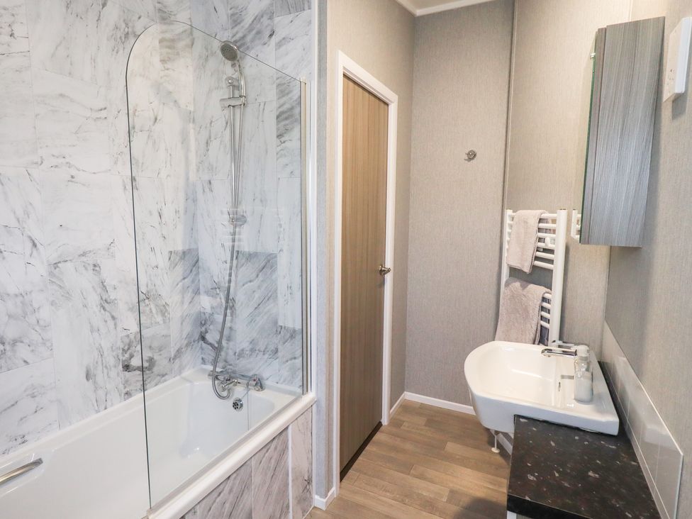 A bathroom with shower and bathtub at Lily's Lodge in Morecambe