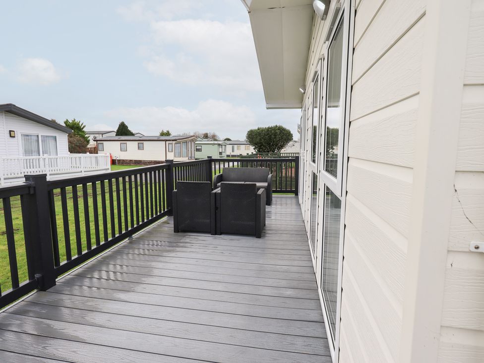 A deck with outdoor furniture at Lily's Lodge in Morecambe