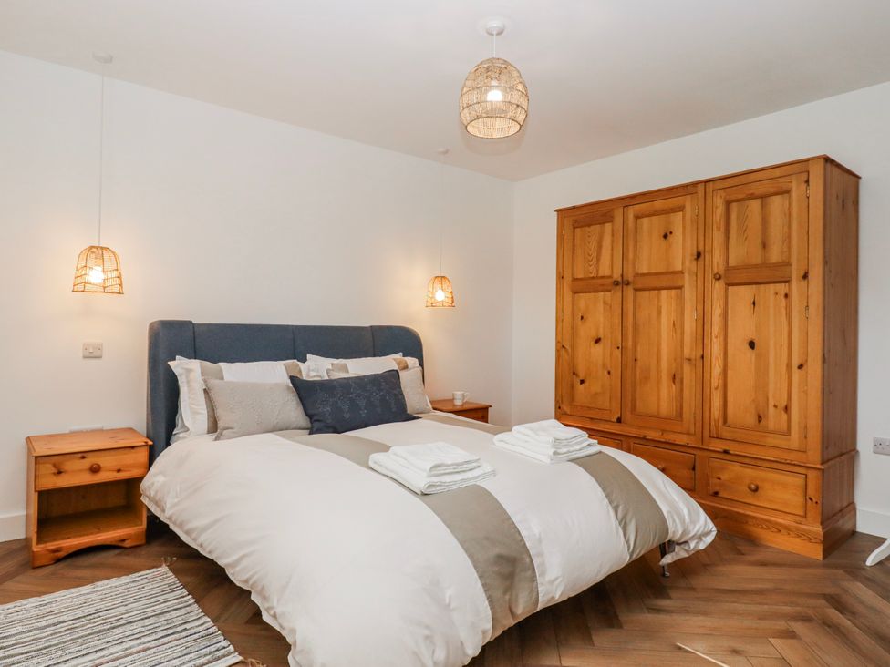 A bedroom with a bed and wardrobe at Shamrock in Exeter