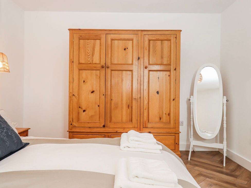 A bedroom with a wardrobe and a mirror at Shamrock in Exeter