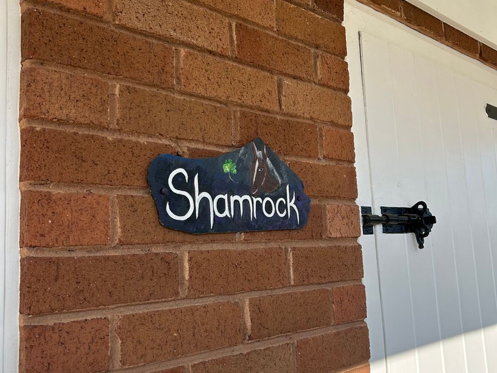 A sign labeled Shamrock on a brick wall at Shamrock Stoke Canon
