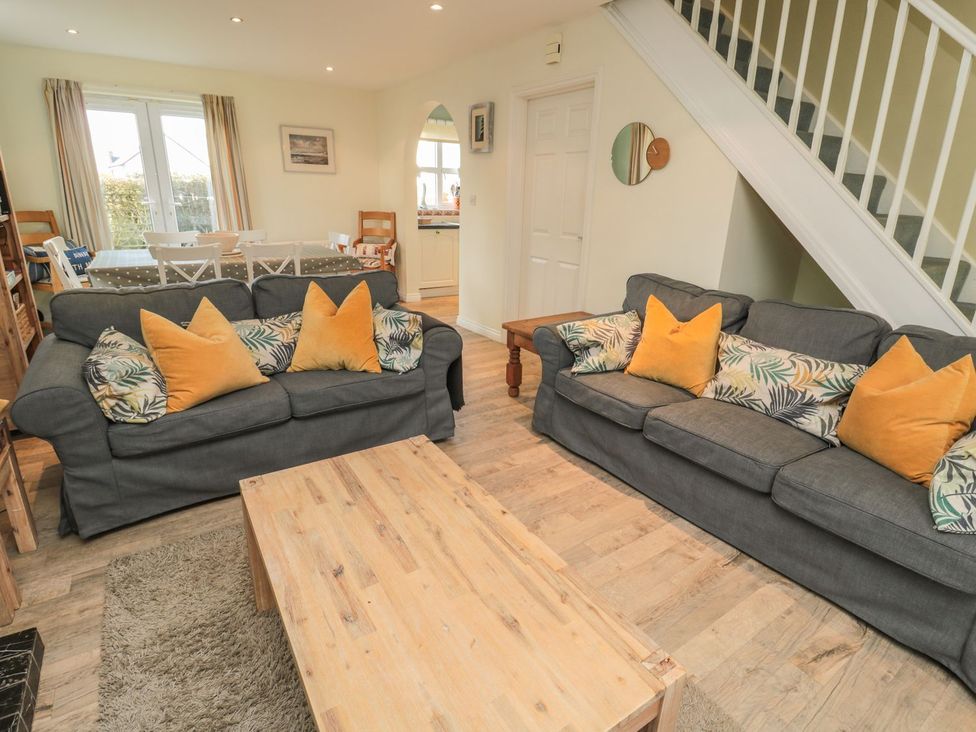 A living room with sofas and a coffee table at Sandy Cove in Chathill