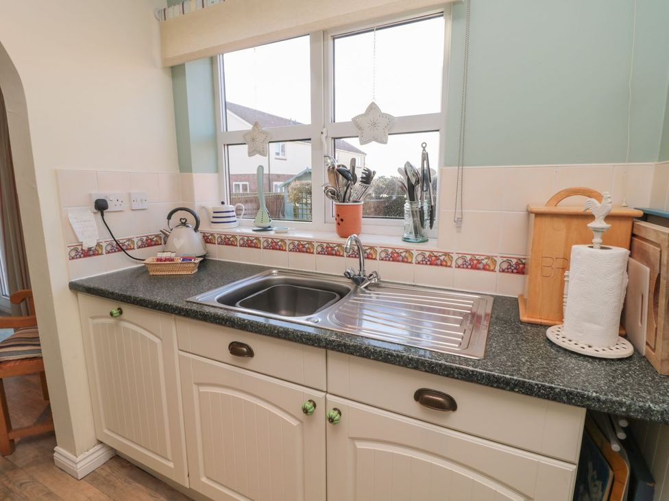 A kitchen with a sink and utensils at Sandy Cove in Chathill