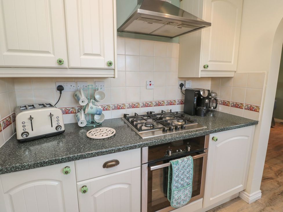 A kitchen with appliances and utensils at Sandy Cove in Chathill