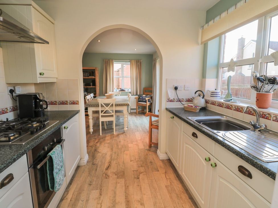 A kitchen with a sink and stove at Sandy Cove, Chathill