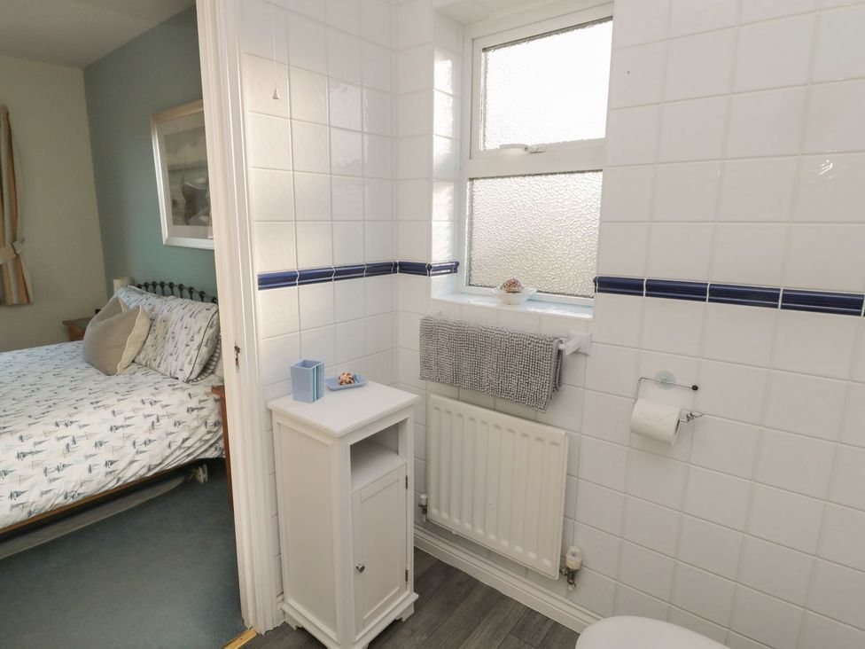 A bathroom with a window and sink at Sandy Cove in Chathill