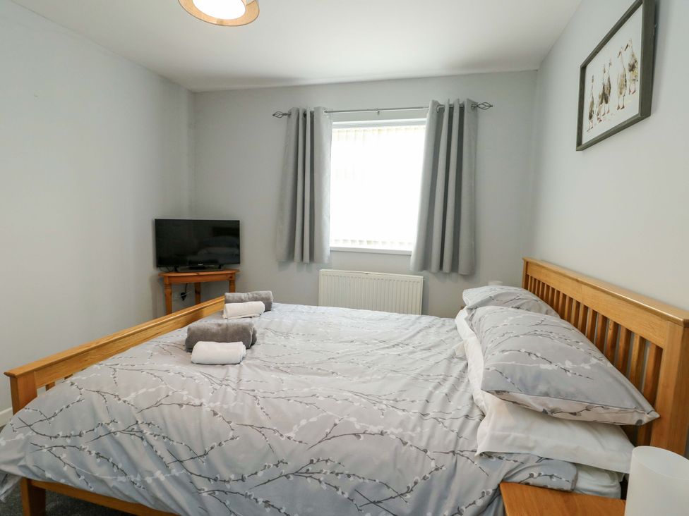 A bedroom with a bed and television at Min Y Cae 