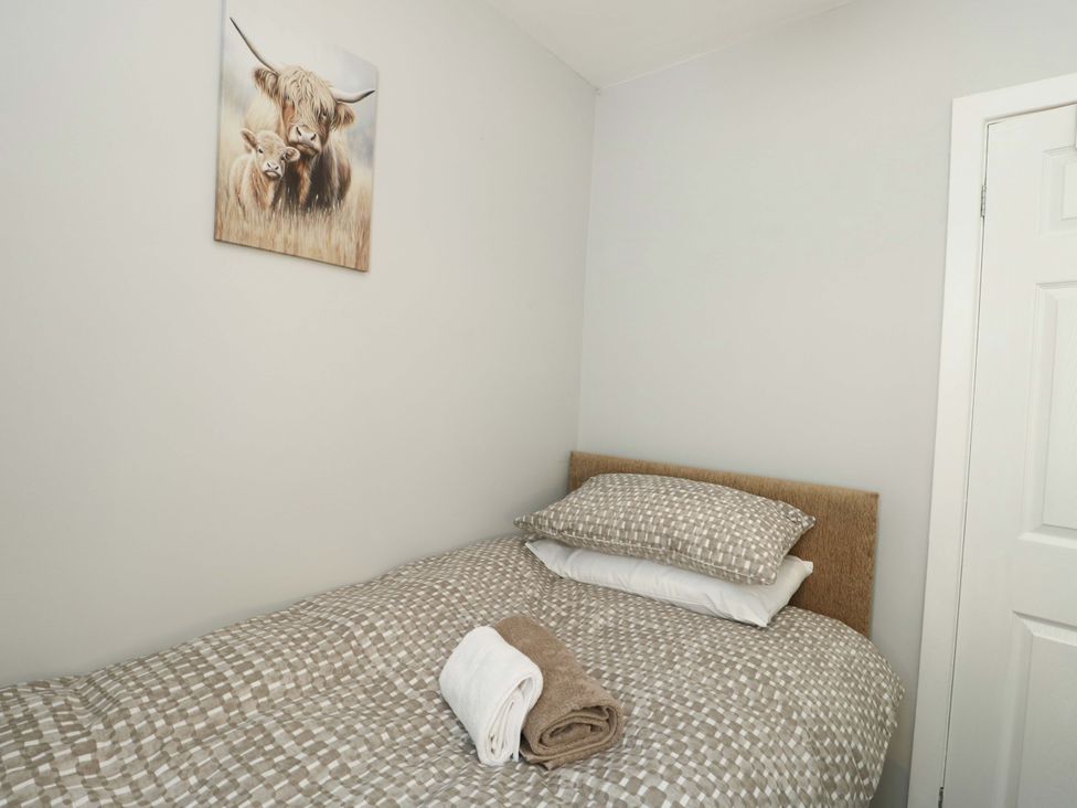 A bedroom with a bed and towels at Min Y Cae in 