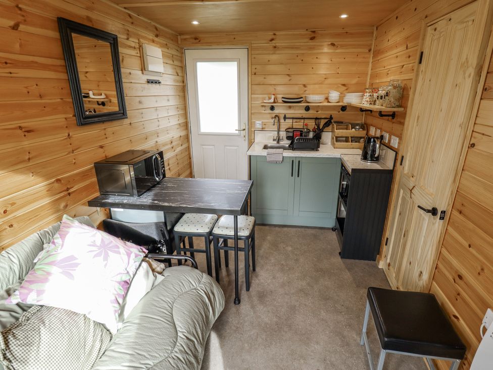 A kitchen with a table and chairs at Mardi Gras in Wisbech