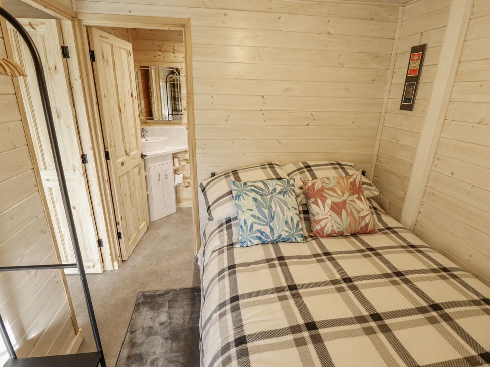 A bedroom with a bed and attached bathroom at Mardi Gras in Wisbech