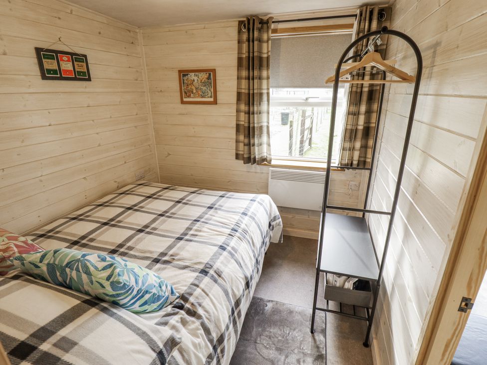 A bedroom with a bed and shelf at Mardi Gras in Wisbech