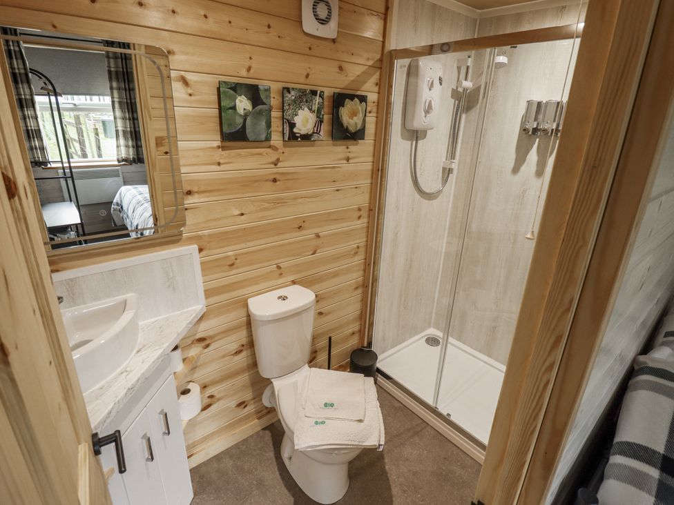 A bathroom with a shower and toilet at Mardi Gras in Wisbech