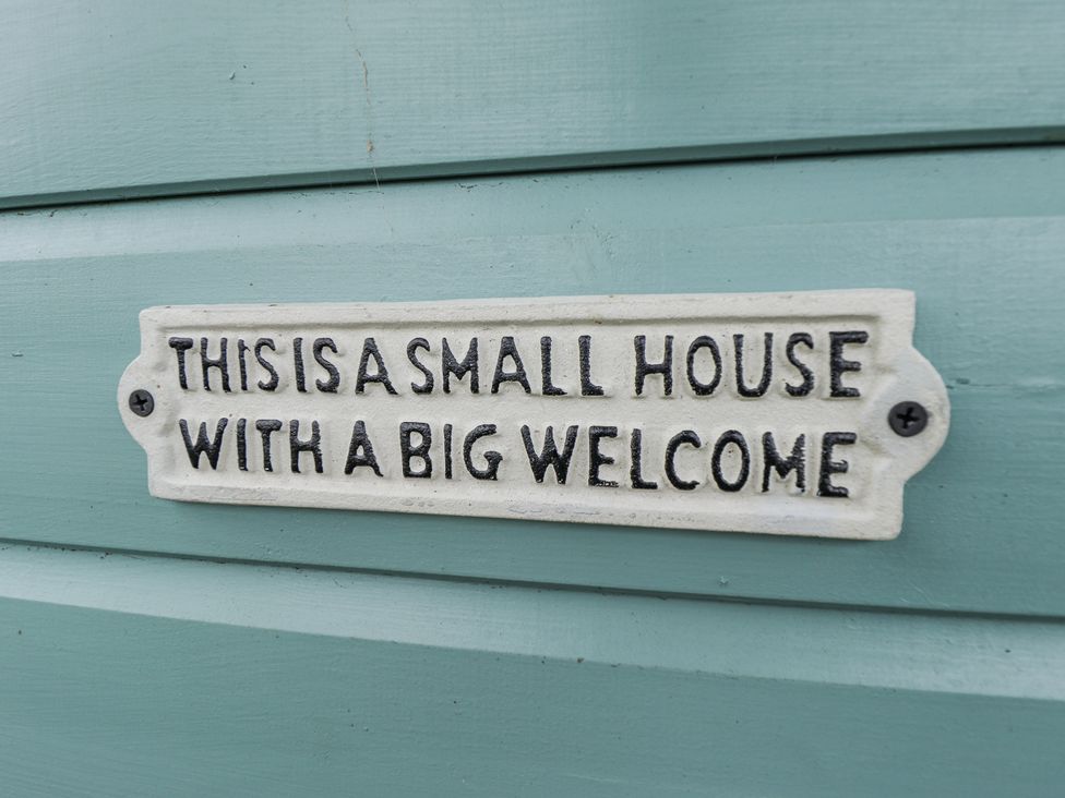 A sign reading This is a small house with a big welcome at Mardi Gras in Wisbech