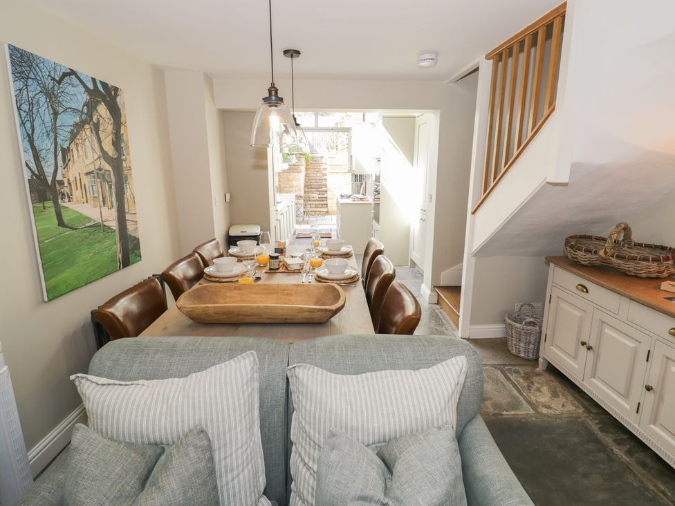 A dining room with a table set for meals at Tea Tree Cottage in Chipping Campden