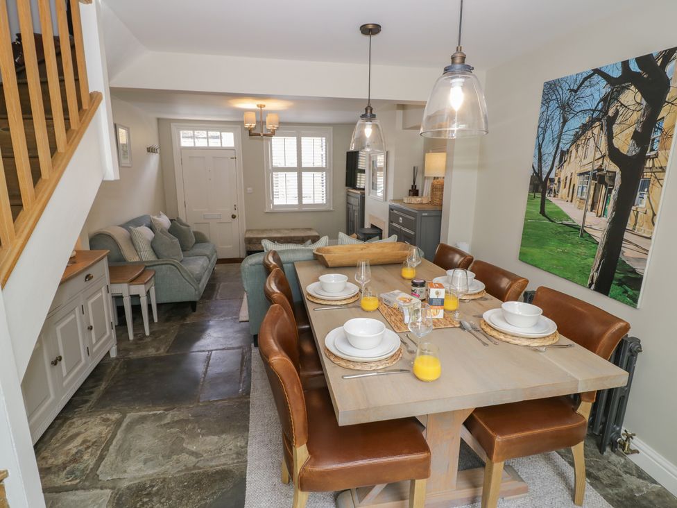 A dining room with a table set for meals at Tea Tree Cottage in Chipping Campden