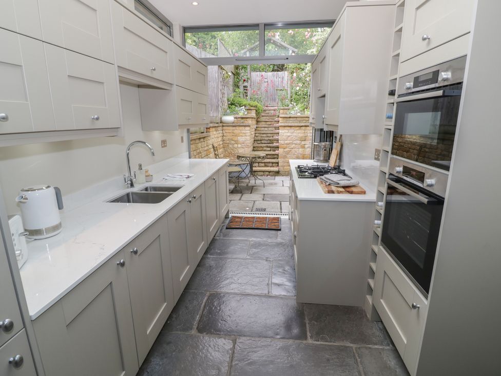 A kitchen with modern cabinetry and appliances at Tea Tree Cottage in Chipping Campden
