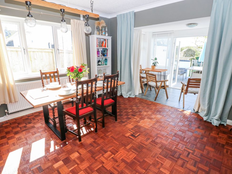A dining room with a table and chairs at Moonraker in Saundersfoot