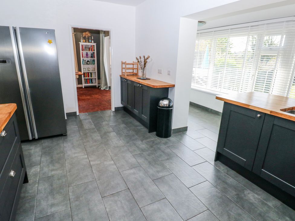 A kitchen with refrigerator and countertop at Moonraker in Saundersfoot