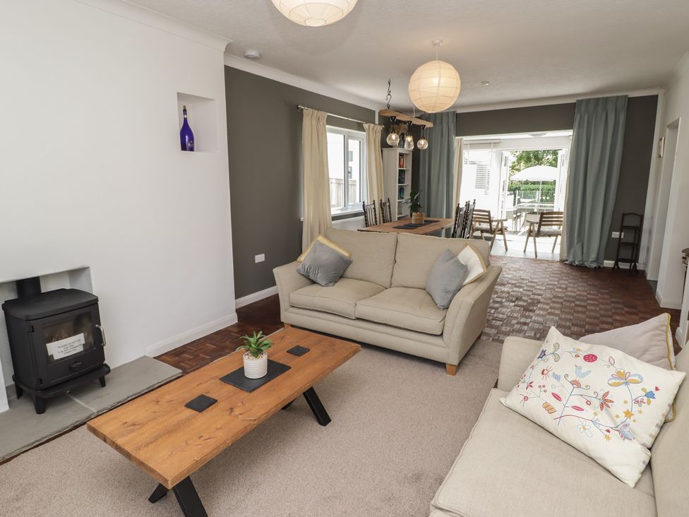 A living room with a coffee table and seating area at Moonraker in Saundersfoot