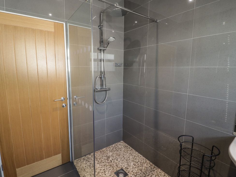 A bathroom with a shower enclosure at Moonraker in Saundersfoot
