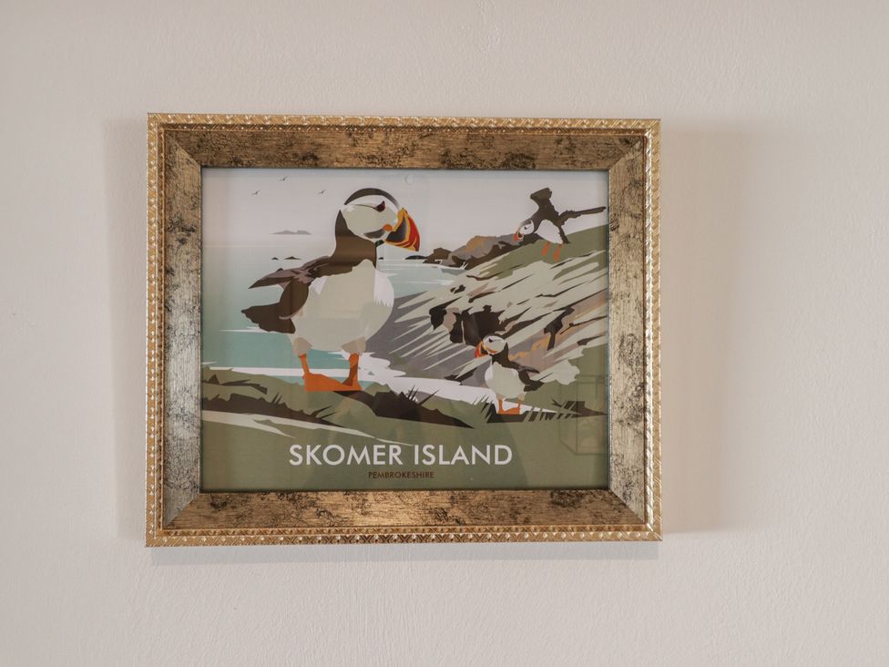 A framed artwork featuring puffins on Skomer Island at Moonraker in Saundersfoot
