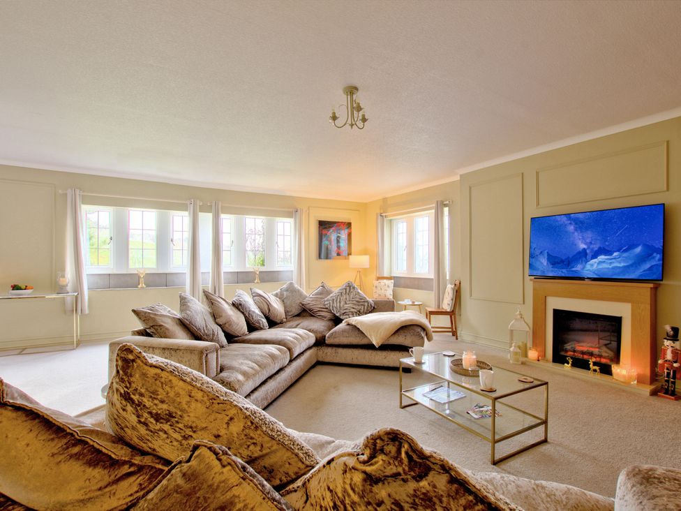 A living room with a sofa and television at River View Cottage in Hanlith near Malham