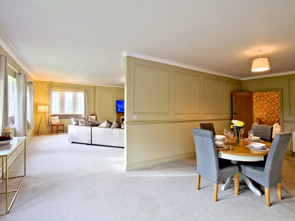 A living room and dining area with a sofa and table at River View Cottage Hanlith near Malham