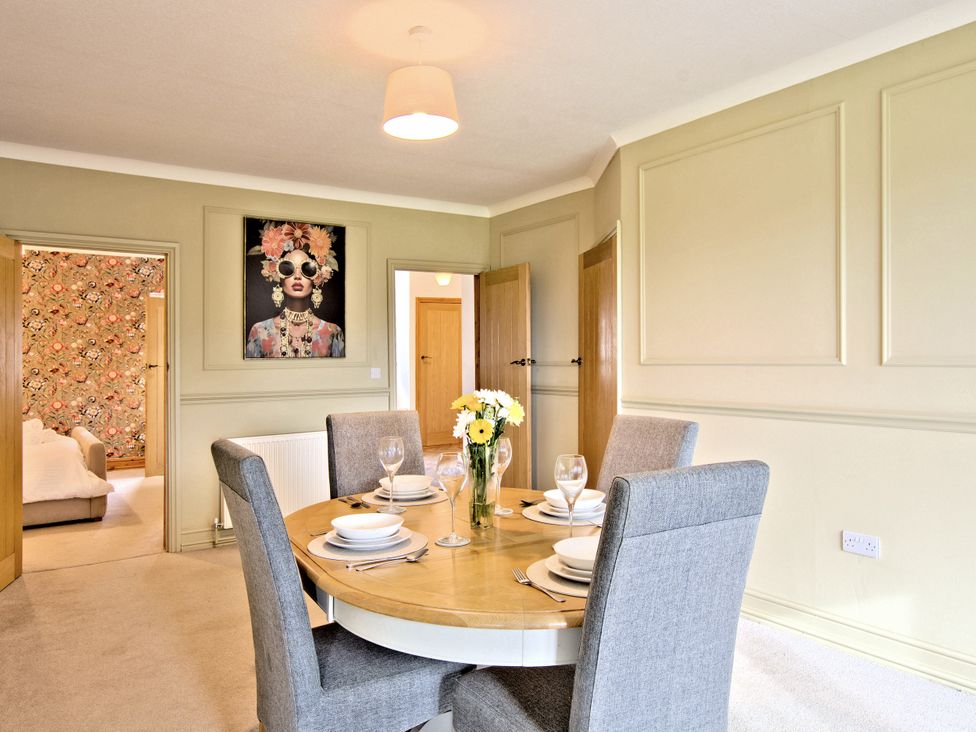 A dining room with a round table and chairs at River View Cottage, Hanlith near Malham