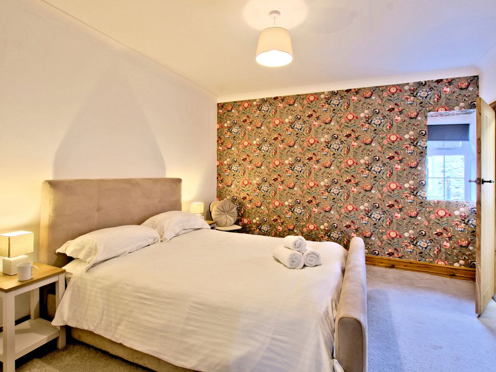 A bedroom with a bed and bedside table at River View Cottage in Hanlith near Malham