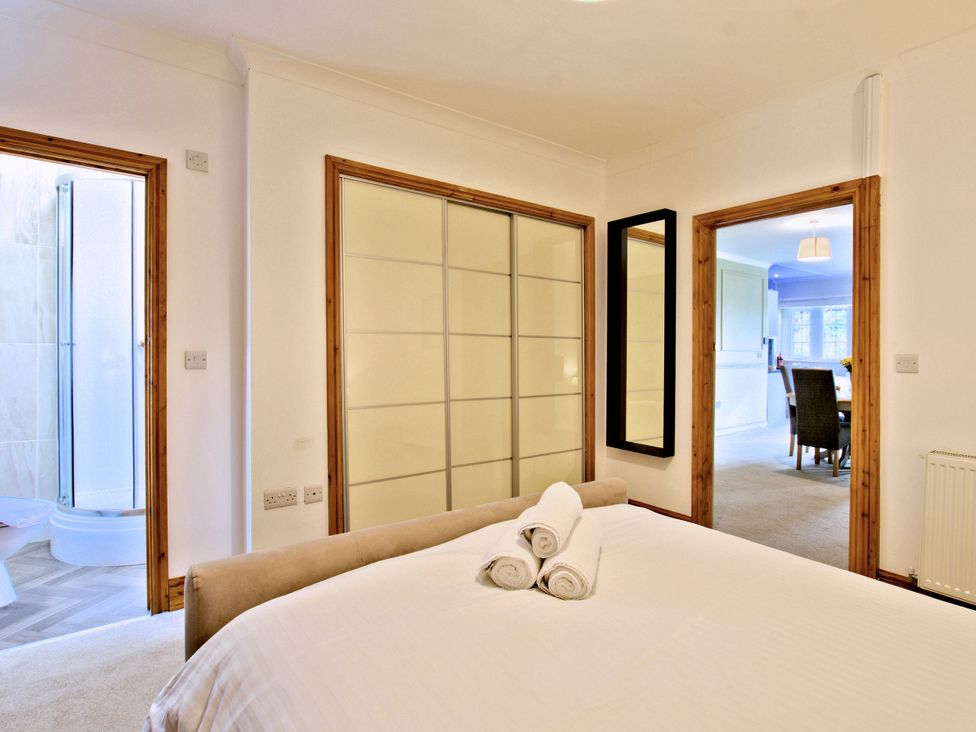 A bedroom featuring a bed with towels at River View Cottage Hanlith near Malham