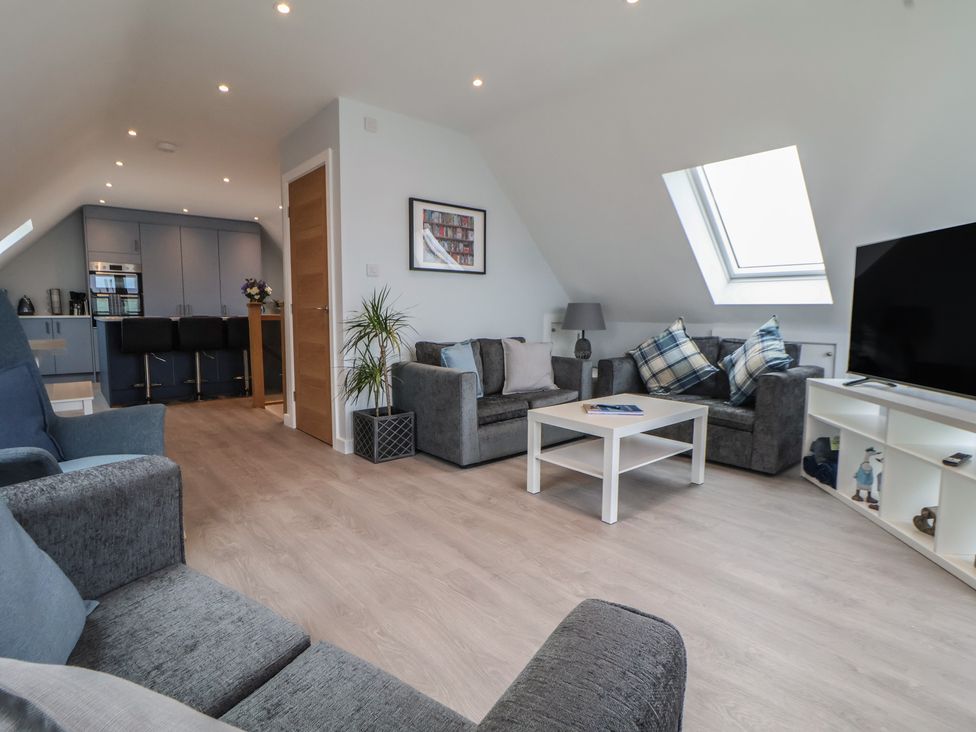 A living room with a sofa and coffee table at Mike’s Place in Rhyl