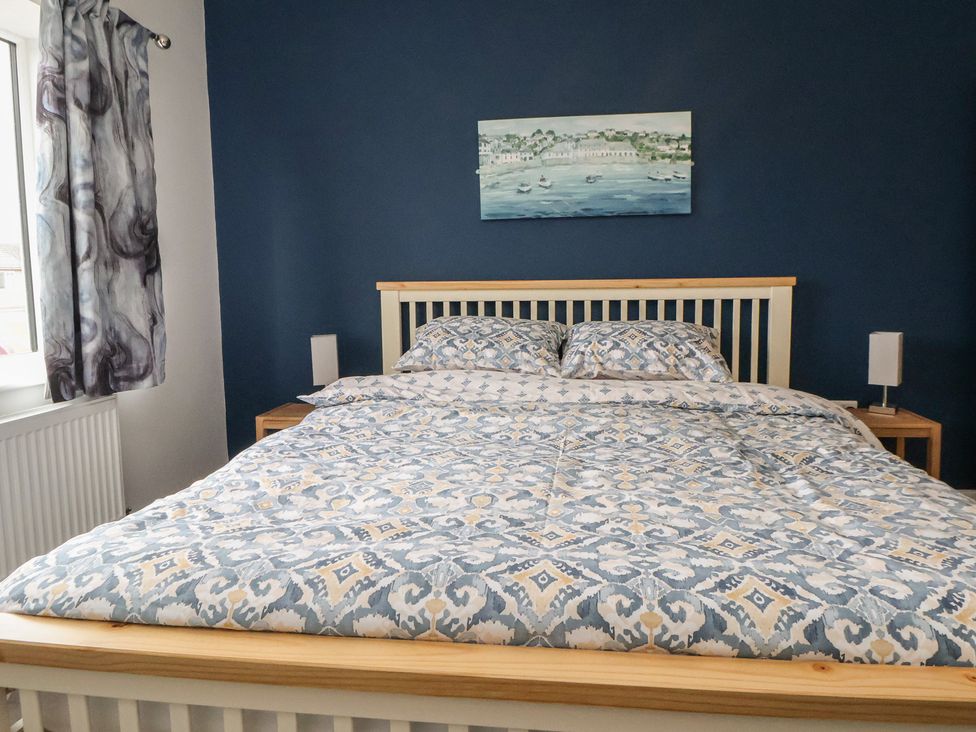 A bedroom with a bed and bedside tables at Mike’s Place in Rhyl