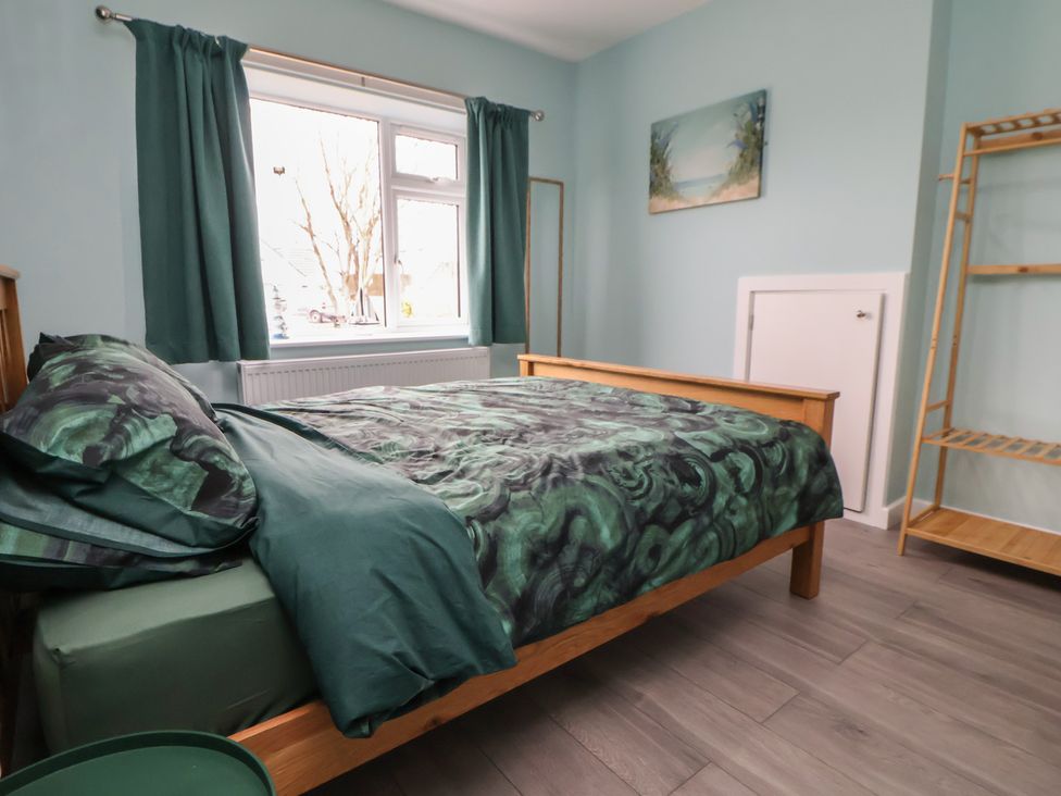A bedroom with a bed and window at Mike’s Place in Rhyl