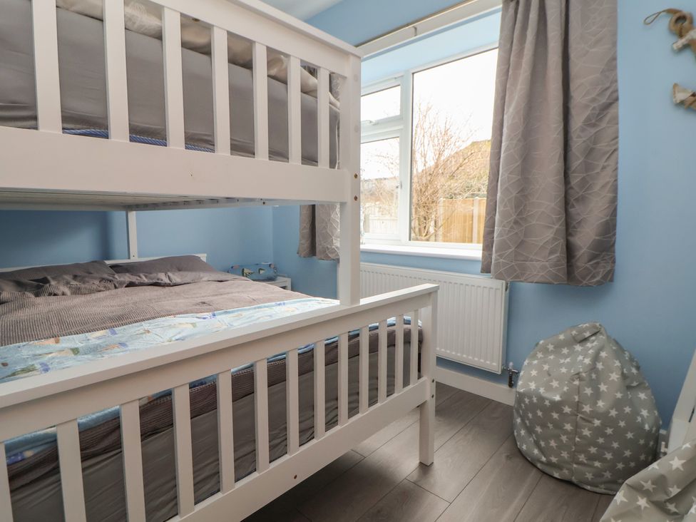 A bedroom with a bunk bed and a bean bag at Mike’s Place in Rhyl