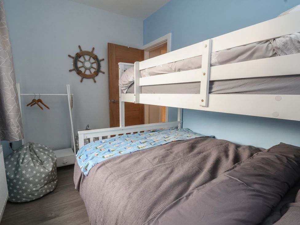 A bedroom with a bunk bed and a bean bag at Mike’s Place in Rhyl